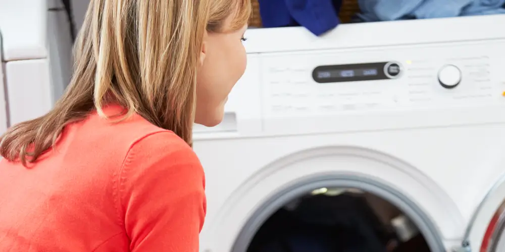 A woman loads the washer