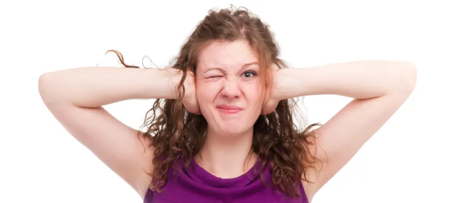 Woman protecting her ears from noise