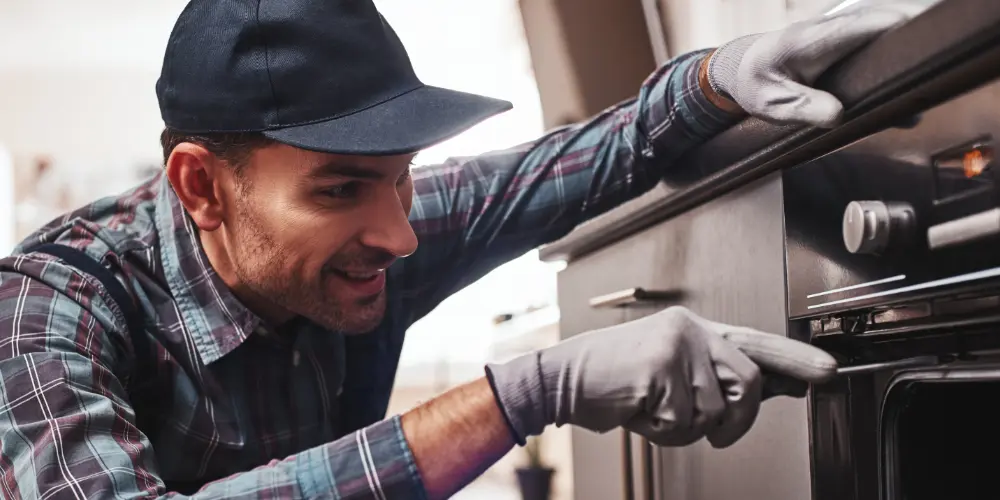 Technician repairing an oven