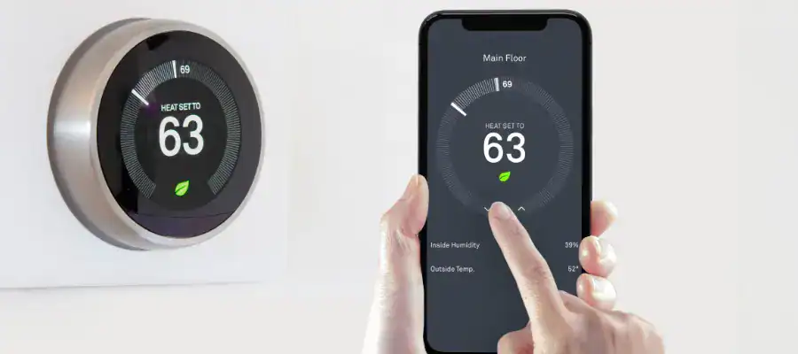 A woman adjusts a smart thermostat